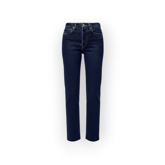 Ygreque's dark indigo 70s stove pipe jeans with a button fly, raw hem, and slight stretch. Fitted through the thigh with a straight leg.