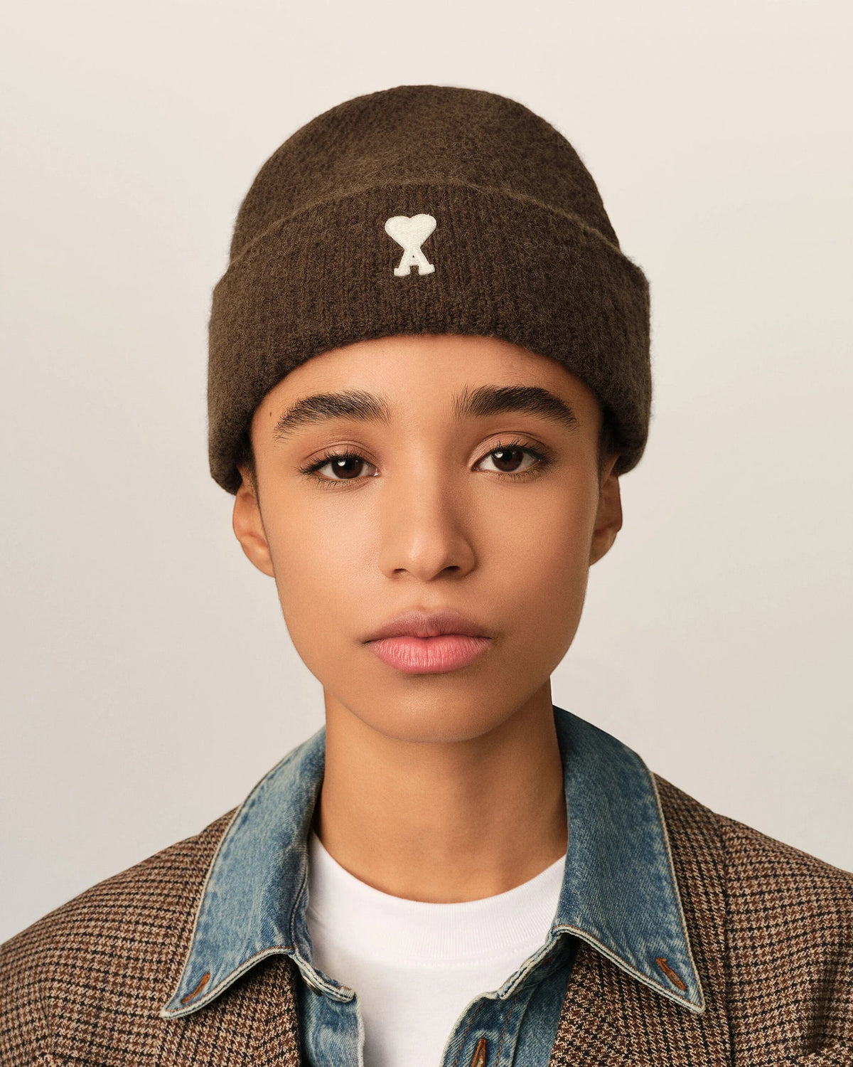 Ygreque Ami Paris unisex chocolate brown alpaca beanie with white Ami de Coeur patch worn by a model