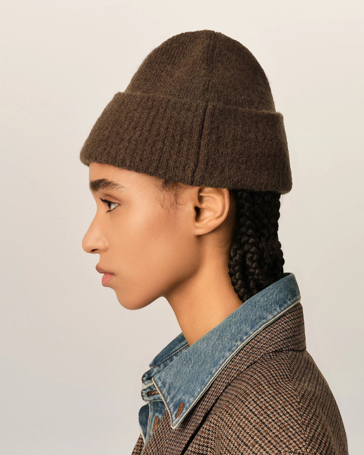 Ygreque Ami Paris unisex chocolate brown alpaca beanie with a cuffed design worn by a model in profile view