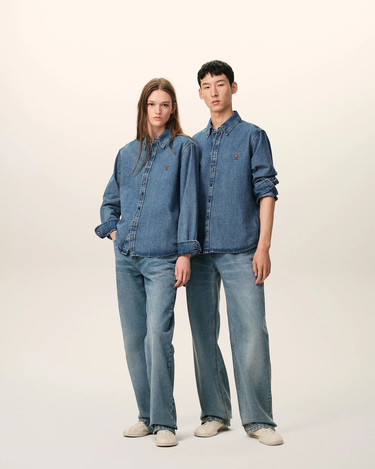 Ygreque Ami Paris unisex light denim shirt in used blue with tobacco Ami de Coeur embroidery worn by two models