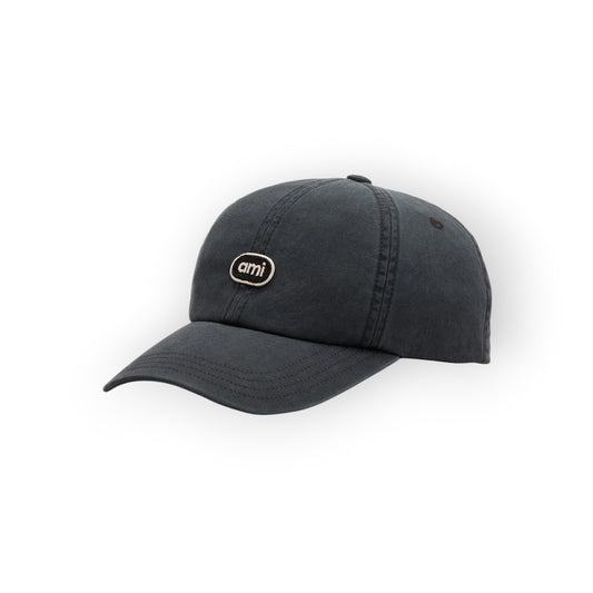 Ygreque Ami Paris washed black cotton baseball cap with a tonal embroidered logo patch and adjustable back strap.