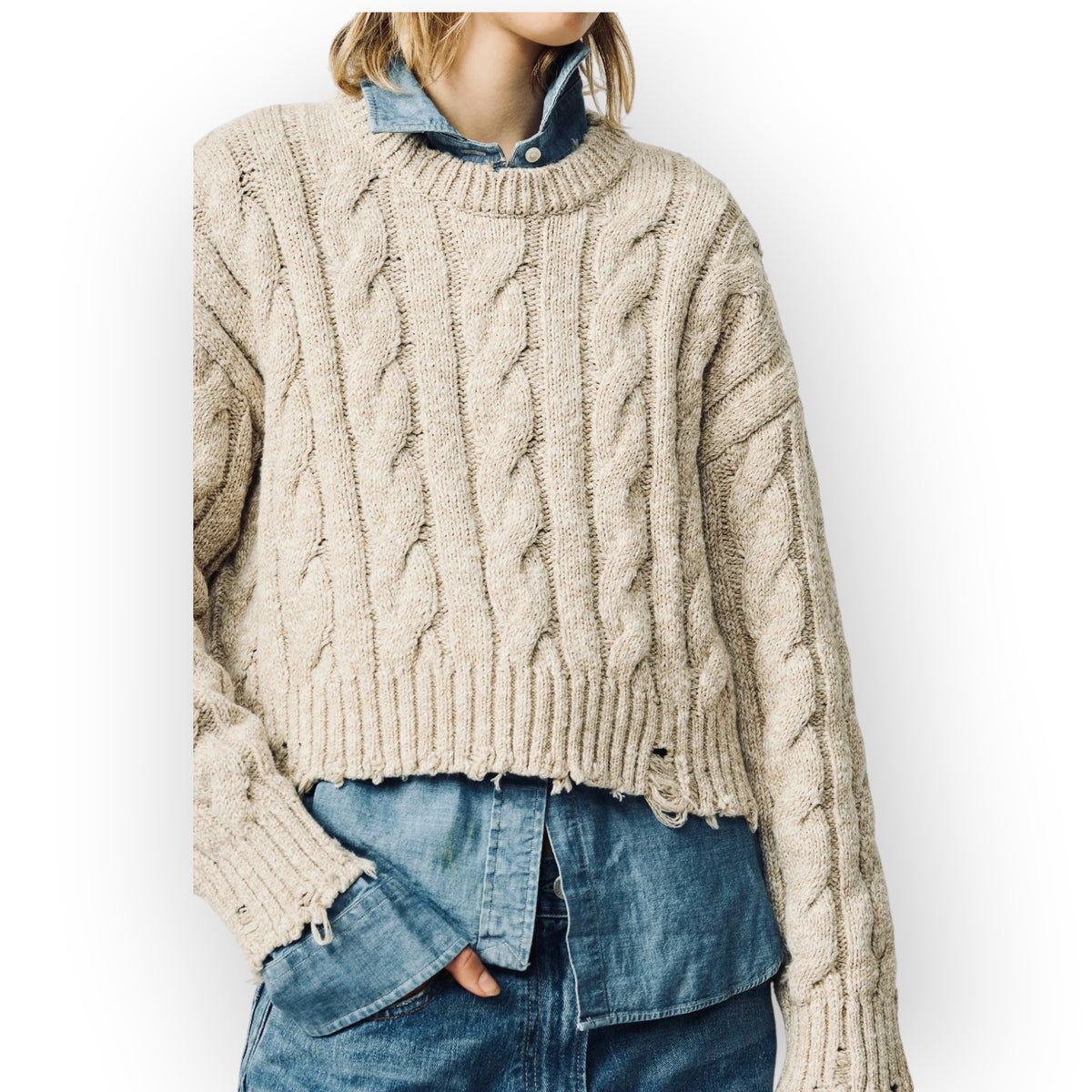 Ygreque Denimist light grey oversized cropped Aran knit sweater with cable knit texture and distressed hem details.