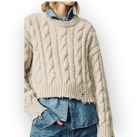 Ygreque Denimist light grey oversized cropped Aran knit sweater with cable knit texture and distressed hem details.