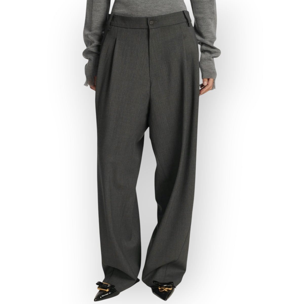 Ygreque Frenken grey wool flannel wide leg trousers with deep front pleats worn by a model