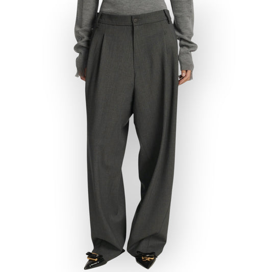 Ygreque Frenken grey wool flannel wide leg trousers with deep front pleats worn by a model